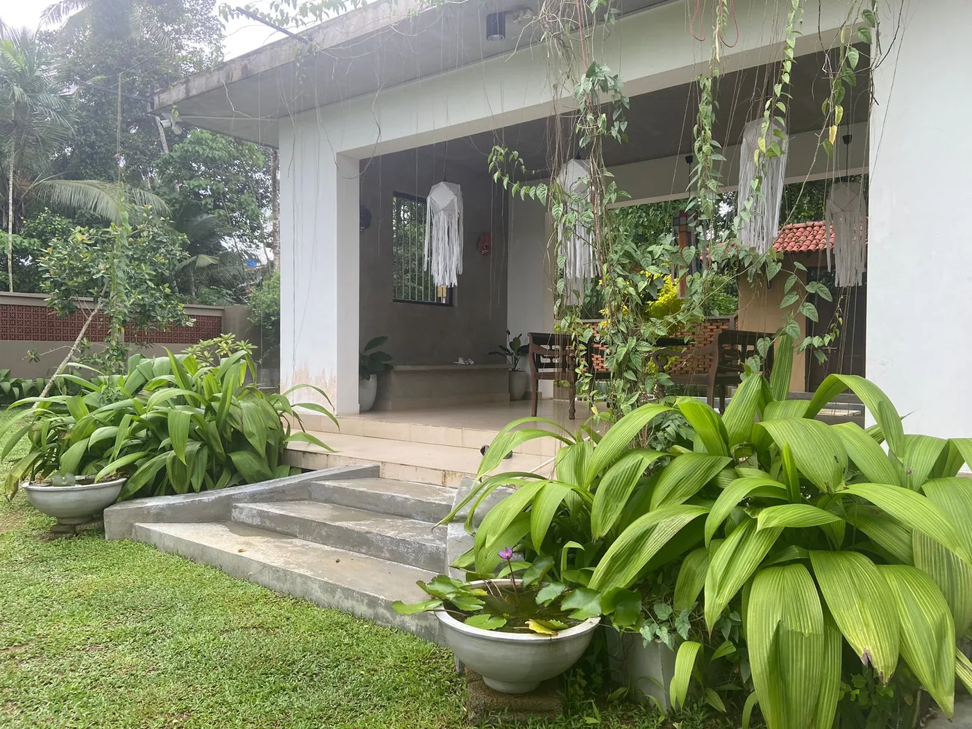 Front veranda at Goraka Villa with plants and garden view